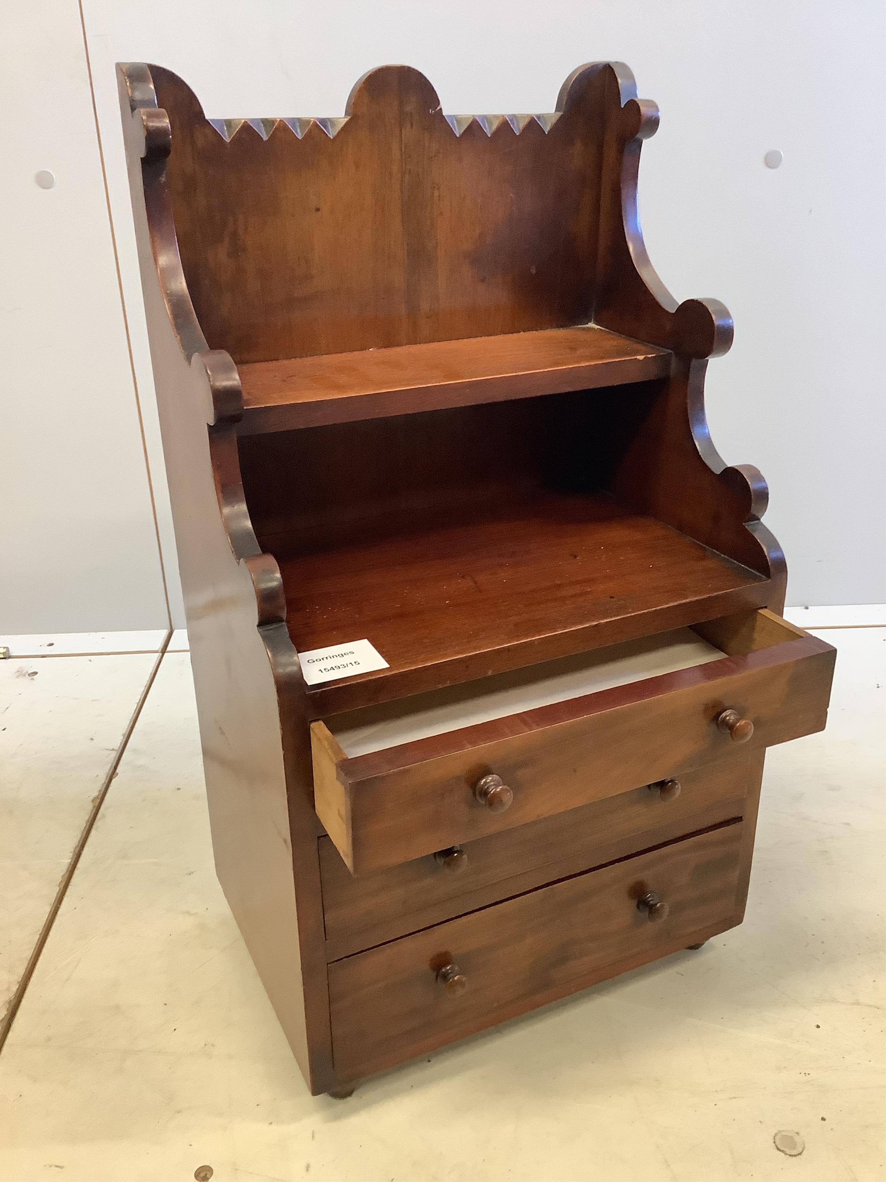 A late Victorian mahogany miniature chest, with a shelf over, width 29cm, depth 20cm, height 54cm. Condition - fair to good